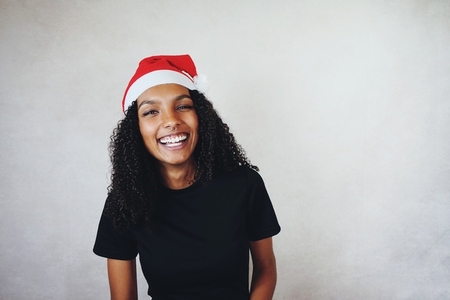 Funny young woman wearing a santas hat