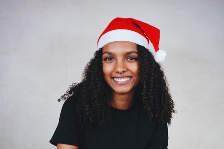 Funny young woman wearing a santas hat