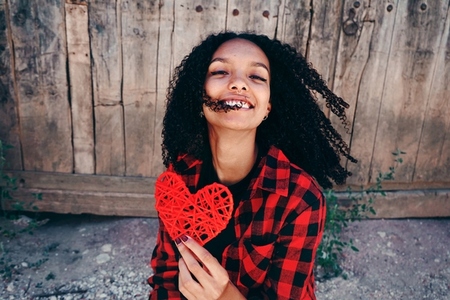 Cheerful young woman with a heart