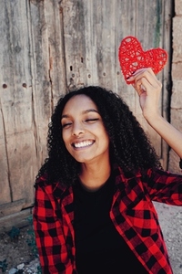 Cheerful young woman with a heart