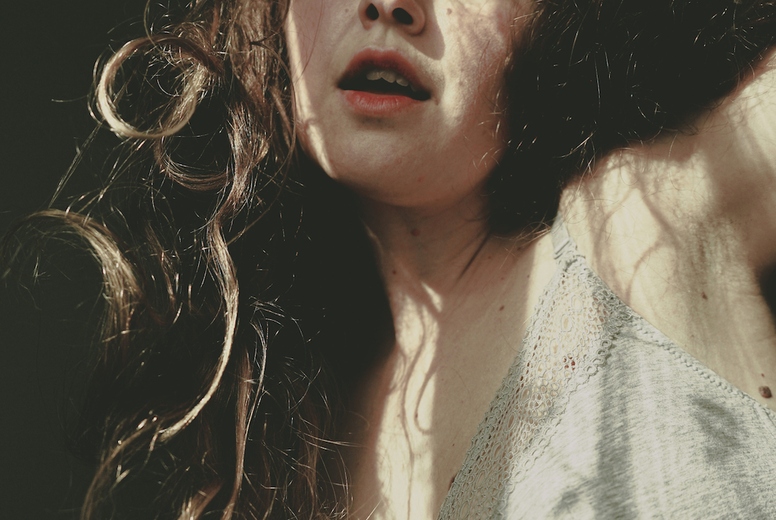 Body positive portrait of a young woman with light and shadows