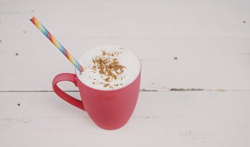 Delicious hot cocoa drink over a pink background