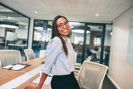 Mid adult businesswoman smiling cheerfully in an office