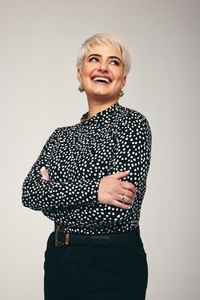 Woman laughing confidently in a studio