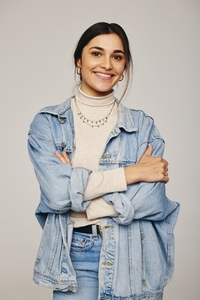 Stylish young woman smiling at the camera in a studio