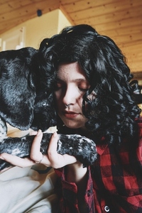 Cute shot of a young woman spending time with her dog