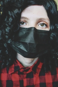 Young woman wearing a black face mask
