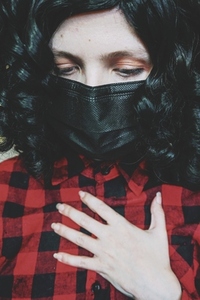 Young woman wearing a black face mask