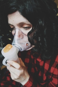 Young woman wearing an oxygen mask