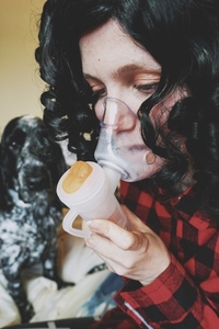 Young woman wearing an oxygen mask