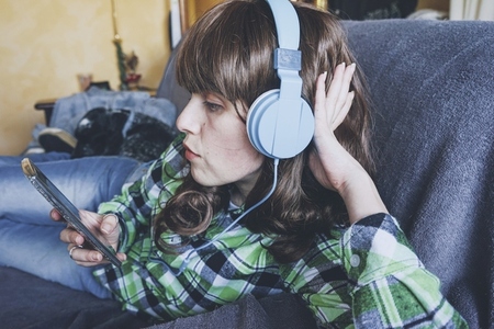 Young woman at home enjoying music