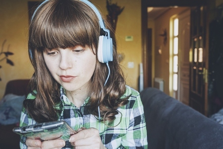 Young woman at home enjoying music