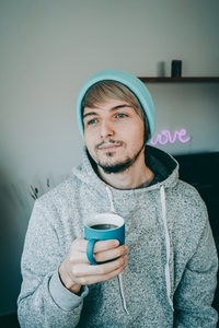 Young man enjoying a cup of coffee at home