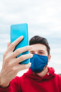 Men using his smartphone with a face mask in Spain
