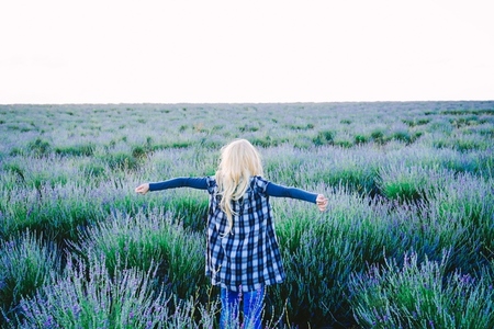 Young blonde woman alone in a lavender field