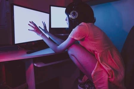 Young streamer woman working at night from home