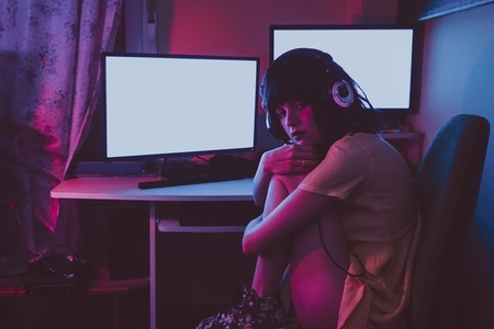 Young streamer woman working at night from home