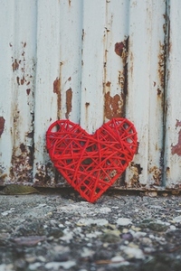 Grunge design of a red heart in an old wall