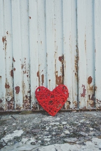 Grunge design of a red heart in an old wall