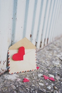 Little red hearts inside of an old envelope