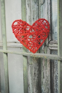 Vintage image with a red heart in a green fence