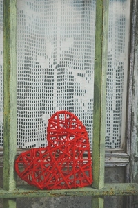 Vintage image with a red heart in a green fence