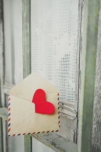 Red heart inside an old envelope
