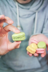 Man holding macarons in his hands