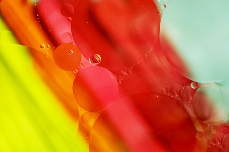 A beautiful and colorful macro of oil bubbles on water with a ye