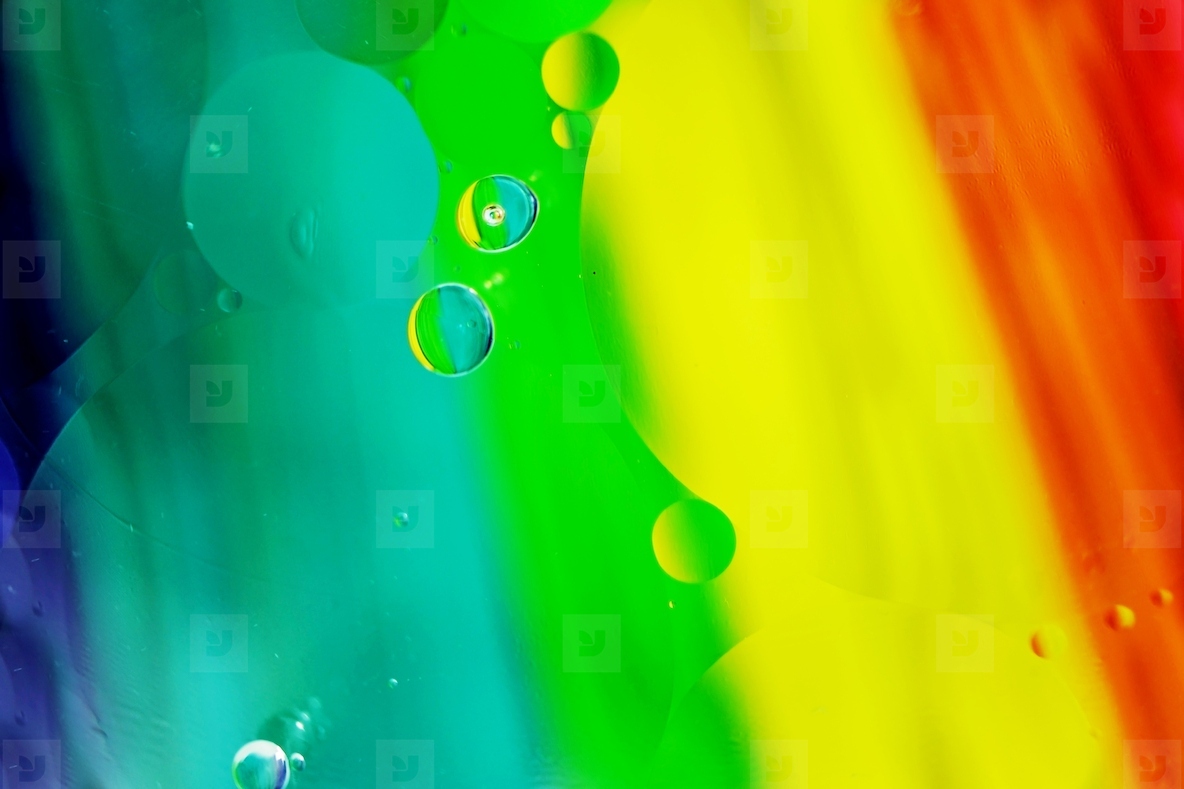 A beautiful and colorful macro of oil bubbles on water with a ye