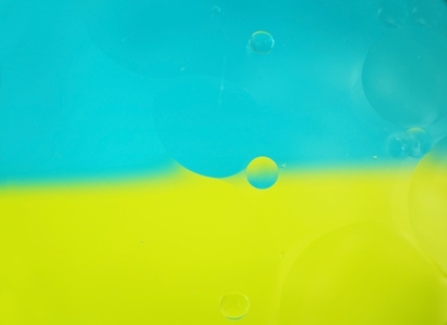 A beautiful and colorful macro of oil bubbles on water with two