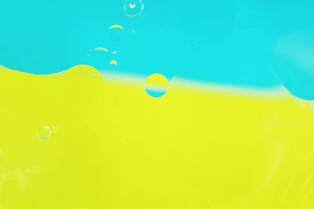 A beautiful and colorful macro of oil bubbles on water with two