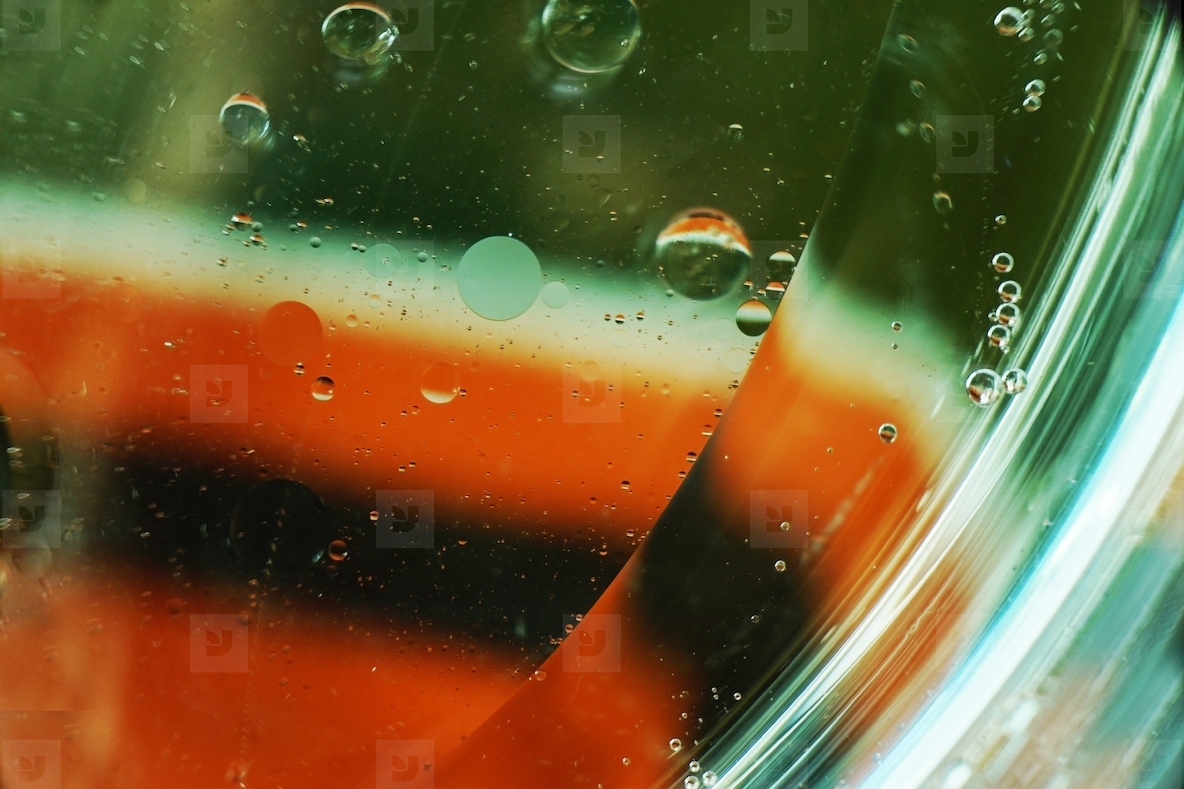 A beautiful and colorful macro of oil bubbles on water with a wh