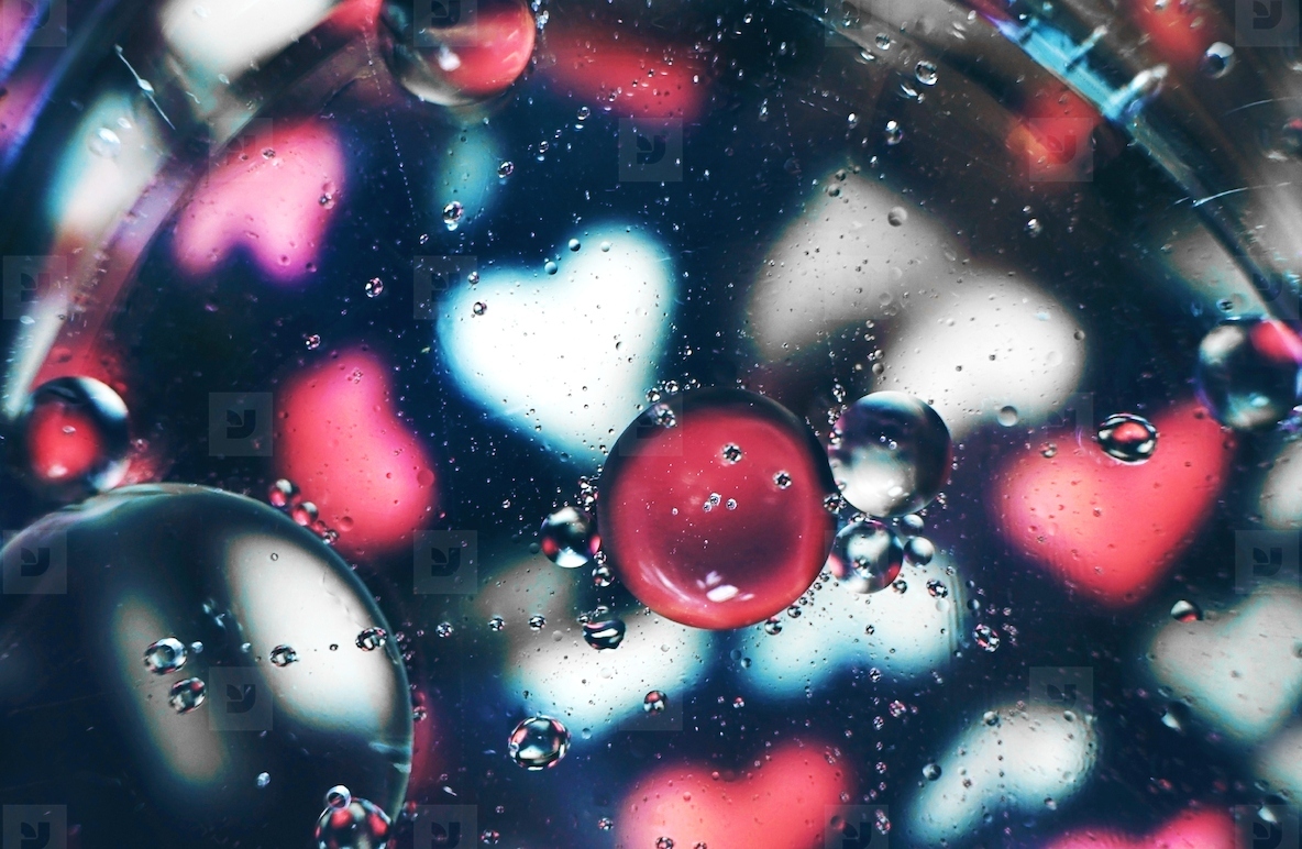 A beautiful and vibrant macro of oil bubbles on water with a blu