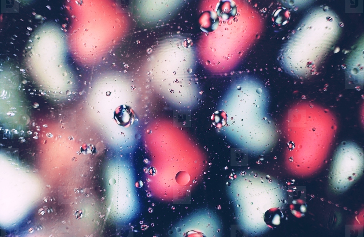 A beautiful and vibrant macro of oil bubbles on water with a blu