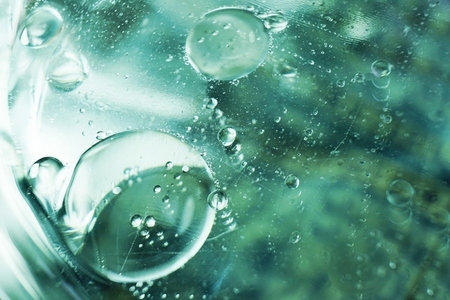 A beautiful and colorful macro of oil bubbles on water with a pl