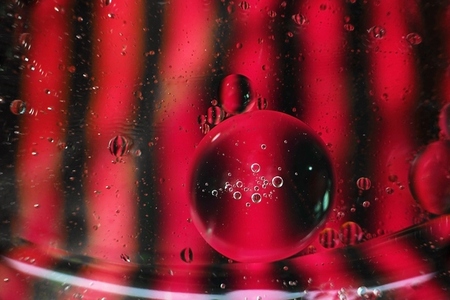 A beautiful and colorful vibrant macro of oil bubbles on water w