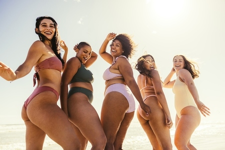 Group of young women dancing in bikinis
