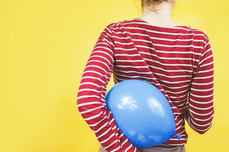 Back view of a girl holding a balloon