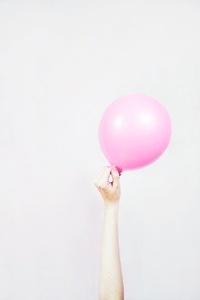 Hand holding a balloon