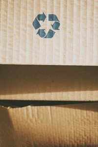Background image of a paper board with a recycling sign