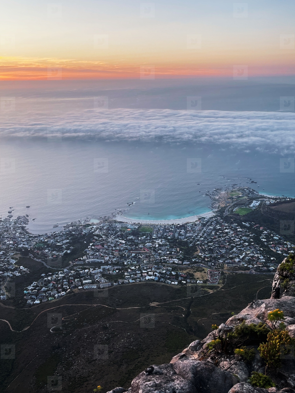 View from above on the city  Ocean with clouds at sunset