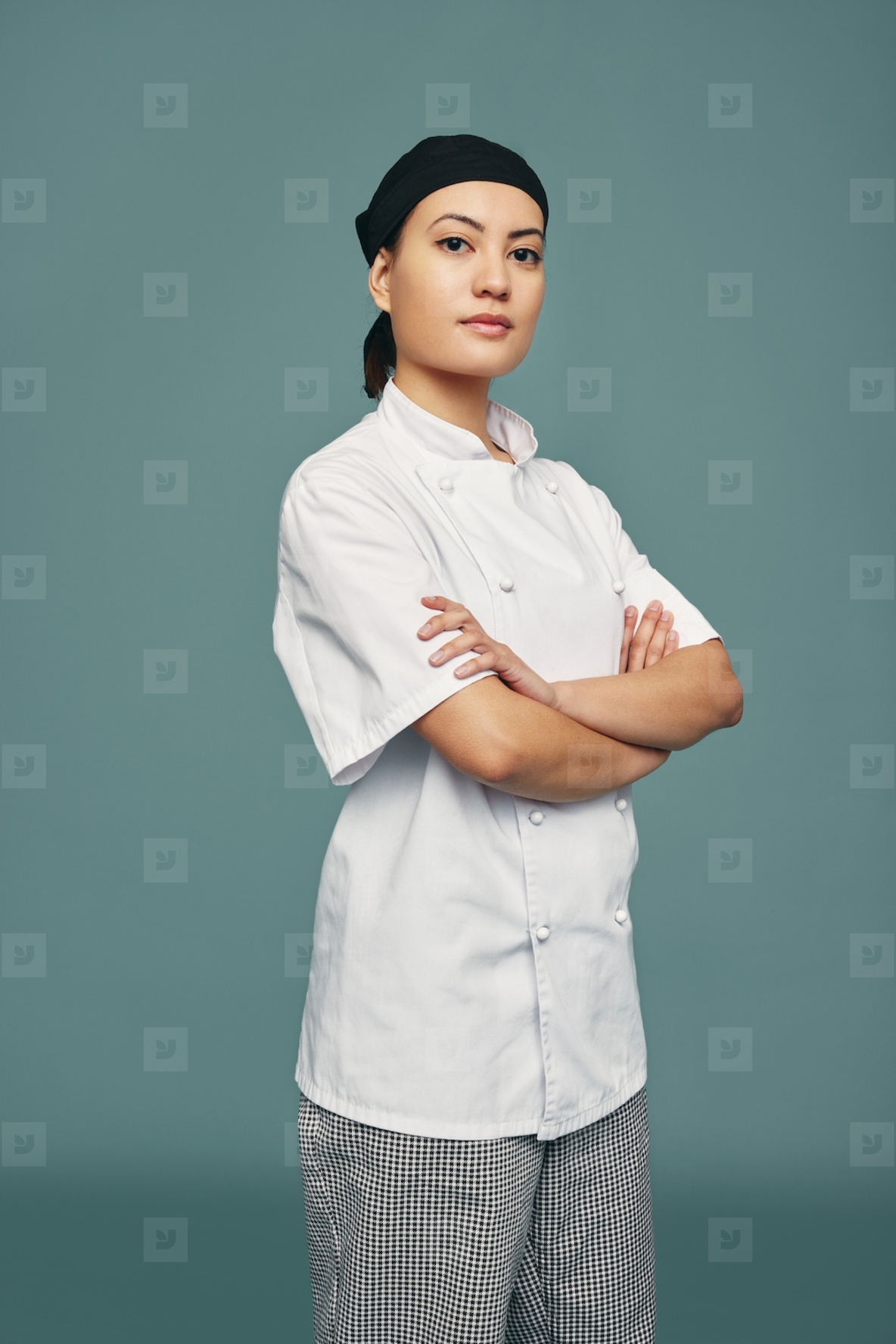 Confident female chef standing in a studio