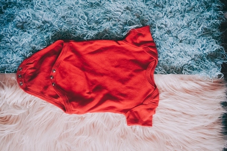 Red baby body against soft background