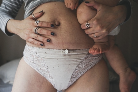 Real image of a woman and her baby at postpartum recovery