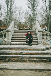 Young woman alone in a old stairs