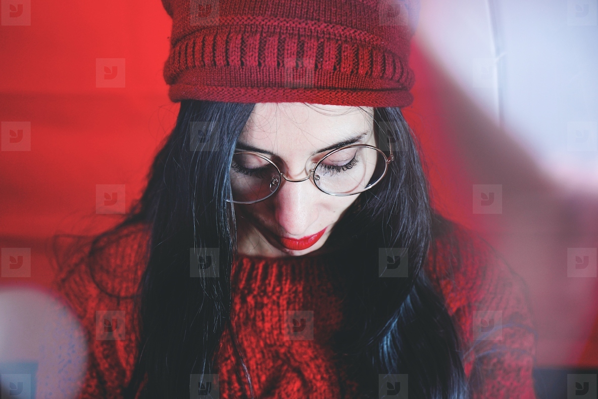 Studio artistic portrait of a brunette woman against red  backgr