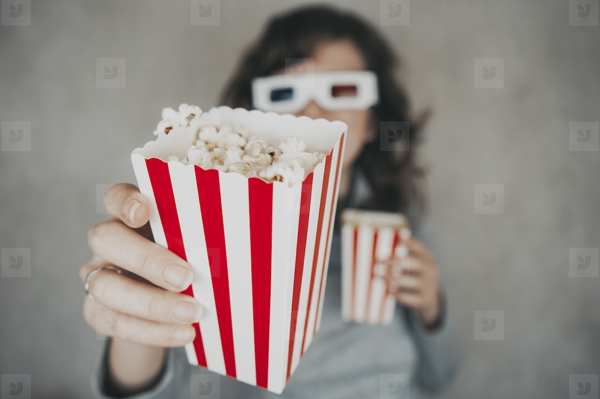 Woman holding a container full of pop corn
