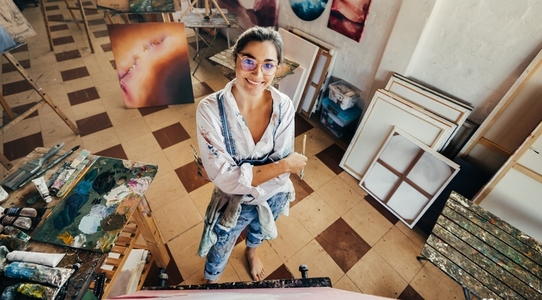 Happy female artist smiling in her art studio