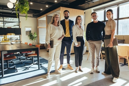 Team of businesspeople standing together in an office
